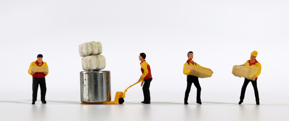 Miniature deliverymen holding parcels. Miniature people.
