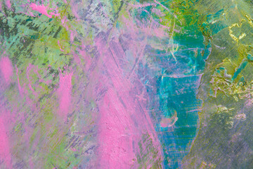 colorful creative motley background: smudged residues of oil paints on a wooden palette, short focus, selective blur