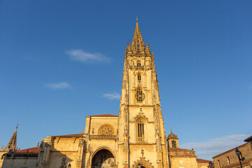 Fototapeta na wymiar Oviedo, Spain - September 4, 2020: The Metropolitan Cathedral Basilica of the Holy Saviour at sunset. Gothic cathedral located in the city of Oviedo, Asturias. It is also known as Sancta Ovetensis.