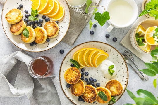 Delicious breakfast with curd fritter,  ricotta fritter or cottage cheese pancakes on ceramic plate. Gourmet healthy delicious morning breakfast
