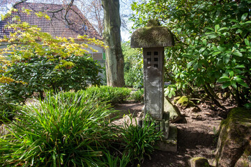 Stone lantern and beauty of nature in japanese garden in Kaiserslautern . Amazing spring sunny day!