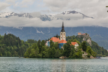 Karawanks mountain range behind Bled lake with the Pilgrimage Church of the Assumption of Maria and Bled Castle, Slovenia