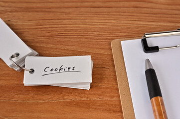 There's a clipboard, a pen and a wordbook stuck to it that says Cookies.