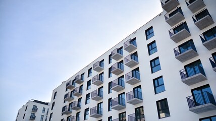 Fototapeta na wymiar Modern apartment building in sunny day. Exterior, residential house facade.
