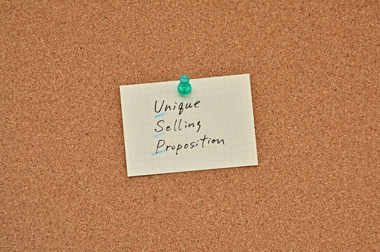 A piece of paper labeled Unique Selling Proposition is pinned to the corkboard.
