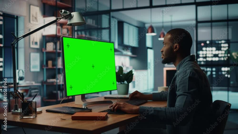 Aufkleber handsome black african american specialist working on desktop computer with green screen mock up dis
