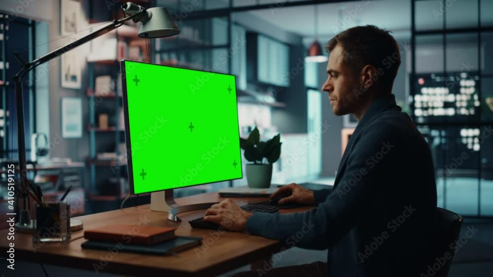 Aufkleber Handsome Caucasian Specialist Working on Desktop Computer with Green Screen Mock Up Display at Home Living Room. Freelance Man Chatting to Clients Over the Internet on Social Networks.