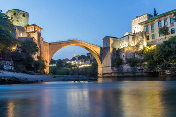 Fototapeta premium Evening view of Stari most (Old Bridge) and old stone buildings in Mostar. Bosnia and Herzegovina