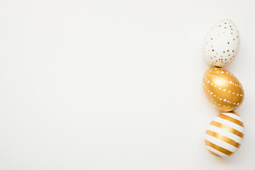 Easter golden decorated eggs isolated on white background. Minimal easter concept. Happy Easter card with copy space for text. Top view, flatlay