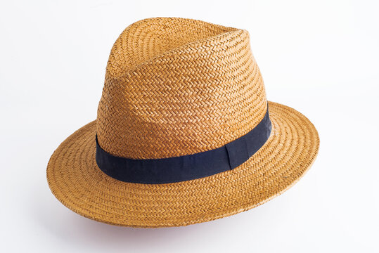 straw hat with black ribbon on white background
