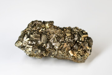 Elongated pyrite fools gold cluster on a neutral white background.