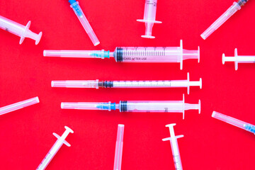 Different syringes injections on a red background