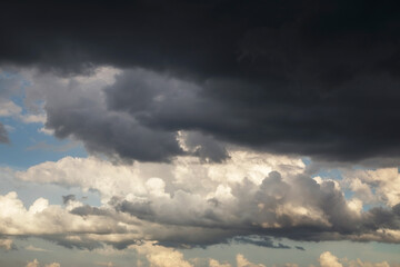 Naklejka na ściany i meble Storm sky with dark grey and white big cumulus clouds background texture, thunderstorm