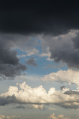 Obraz premium Blue sky behind dark storm clouds background texture, thunderstorm