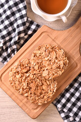 Round shortbread almond biscuits on wooden tray 