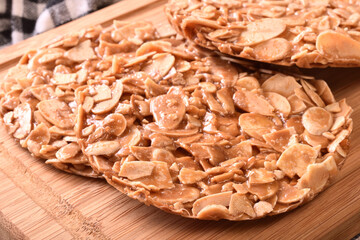 Round shortbread almond biscuits on wooden tray 