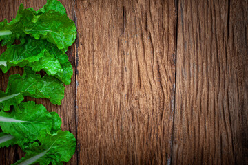 Bio food. green Lettuce leaves pattern on old wooden background, copy space 
