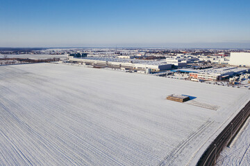 Aerial view of the trucks unloading at the logistic center. Drone photography.