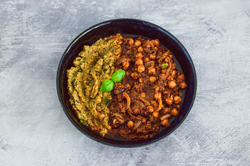 plant-based food, vegan moroccan cous cous with chickpea onion and mushroom stew with plenty of spices and herbs