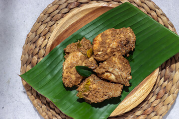 Rendang ayam or chicken rendang is a traditional dry curry delicacy with various spices. Malaysian and Indonesian chicken stew with spices and coconut milk.