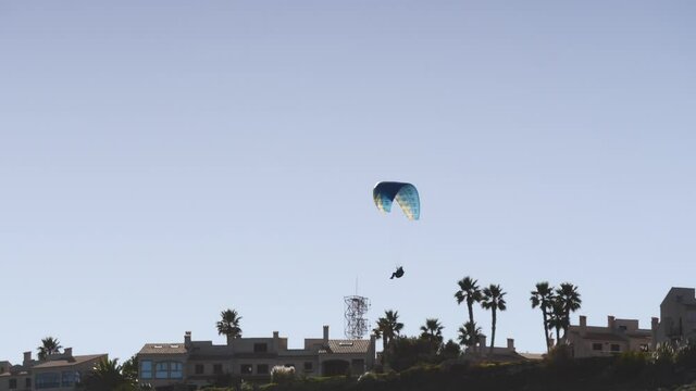 Paragliding. Extreme sport. Paraglider silhouette flying in the sky. Spain Alicante Santa Pola region.