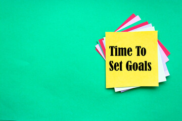 Time To Set Goals, the phrase is written on multi-colored stickers, on a green background. Business concept, strategy, plan, planning.