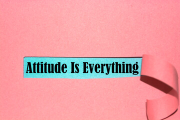 Attitude Is Everything text written behind a torn paper