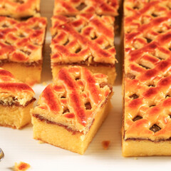 Nastar Cake, Lattice Pie, Pineaple Jam, and Chiffon Cake at the Bottom. Cut Square Slice on WHite Background. Delicious Homemade Cake