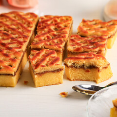 Nastar Cake, Lattice Pie, Pineaple Jam, and Chiffon Cake at the Bottom. Cut Square Slice on White Background. Delicious Homemade Cake. Served on Imlek or Chinese New Year