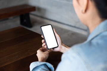 cell phone blank white screen mockup.woman hand holding texting using mobile on desk at office.background empty space for advertise.work people contact marketing business,technology