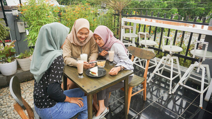 Asian group hijab woman smilling in cafe with friend