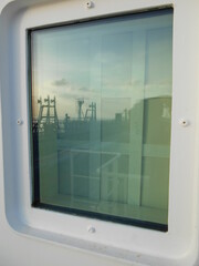 View of the room window of a ship in port