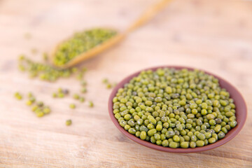 A plate of fresh mung beans and scattered beans