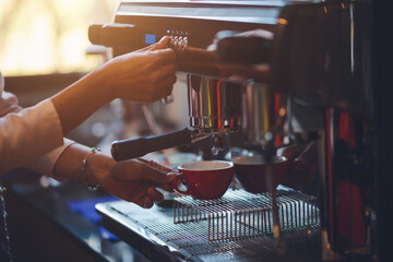 Barista making coffee in coffeeshop