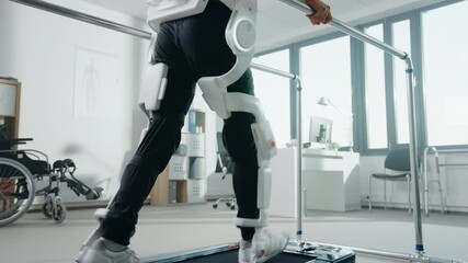 Modern Hospital Physical Therapy: Patient with Injury Walks on Treadmill Wearing Advanced Robotic Exoskeleton Legs. Physiotherapy Rehabilitation Technology to Make Disabled Person Walk. Focus on Legs