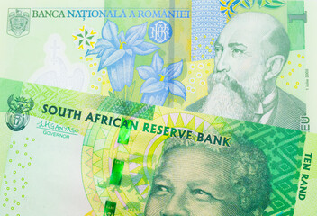 A macro image of a shiny, green 10 rand bill from South Africa paired up with a green, plastic one leu bank note from Romania.  Shot close up in macro.