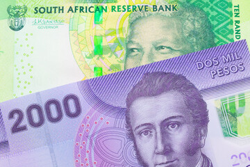 A macro image of a shiny, green 10 rand bill from South Africa paired up with a purple, plastic two thousand Chilean peso bank note.  Shot close up in macro.