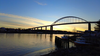 Fototapeta na wymiar The silhouette of Chesapeake City bridge during sunset near Maryland, U.S