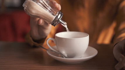 mug with a drink adding sugar cafe rest