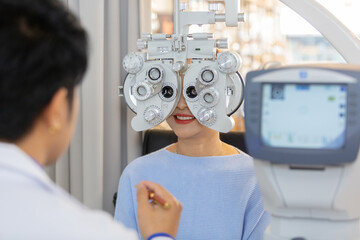 asian middle age woman eye exam with diagnostic ophthalmology in optical clinic. professional...