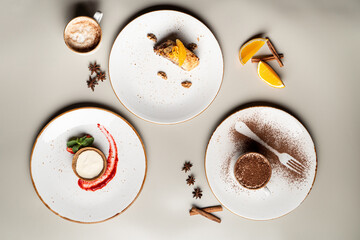 Different desserts isolated on white studio background: tiramisu, orange cake and parfait