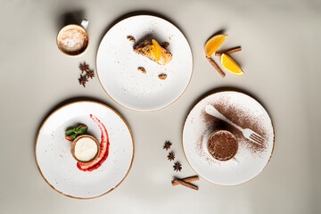 Different desserts isolated on white studio background: tiramisu, orange cake and parfait