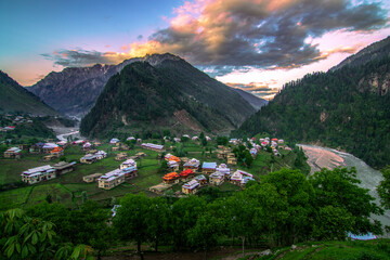 landscape of mountains valley with red top huts and green meadows in neelam valley  Kashmir 