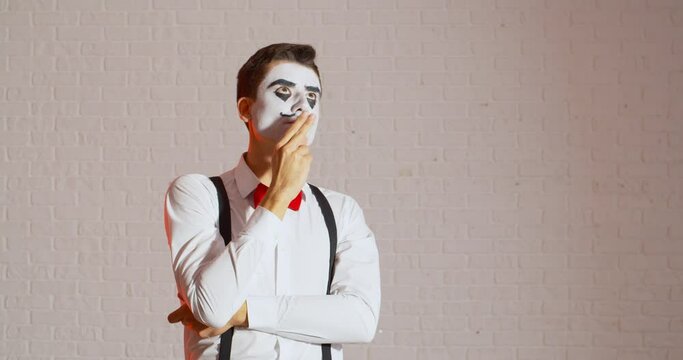 Smoking miming male artist on light background