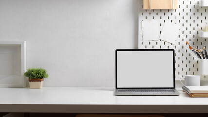 Workspace with laptop, stationery, decorations and copy space in home office room