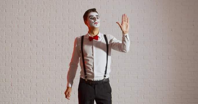 Miming male artist on white background
