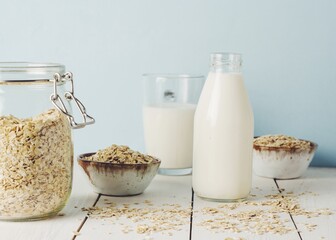 Vegan oat milk, non dairy alternative milk in a glass close up