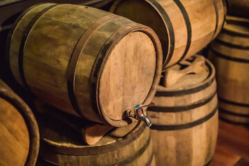 Wine barrels stacked in the old cellar of the winery