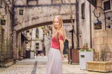 Naklejka premium Young woman tourist walks down the street in a European city after the end of COVID-19 coronavirus. quarantine is over