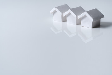 Three 3D white houses model in a row for real estate property, housing development or community
